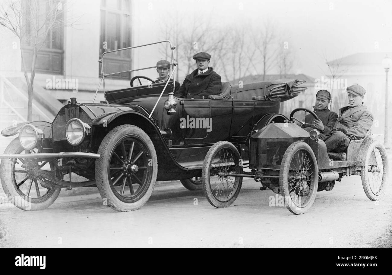 Two men driving a large automobile and two men driving a small automobile ca. early 1900s (1910s or 1920s) Stock Photo