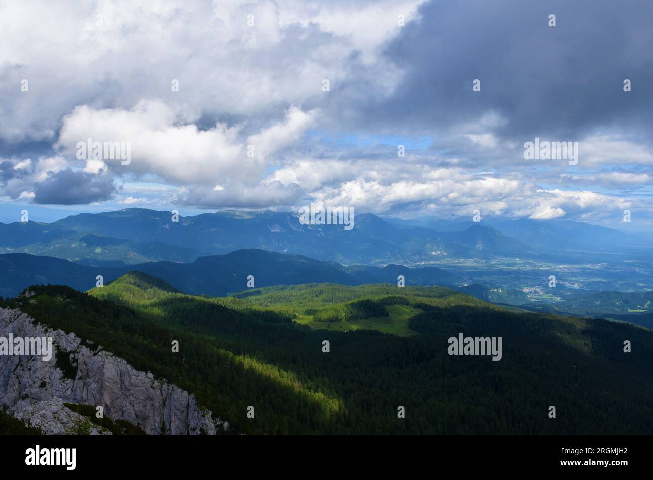 Scenic view of Gorenjska region of Slovenia and Karavanke mountain with clouds above and Pokljuka plateau in front Stock Photo
