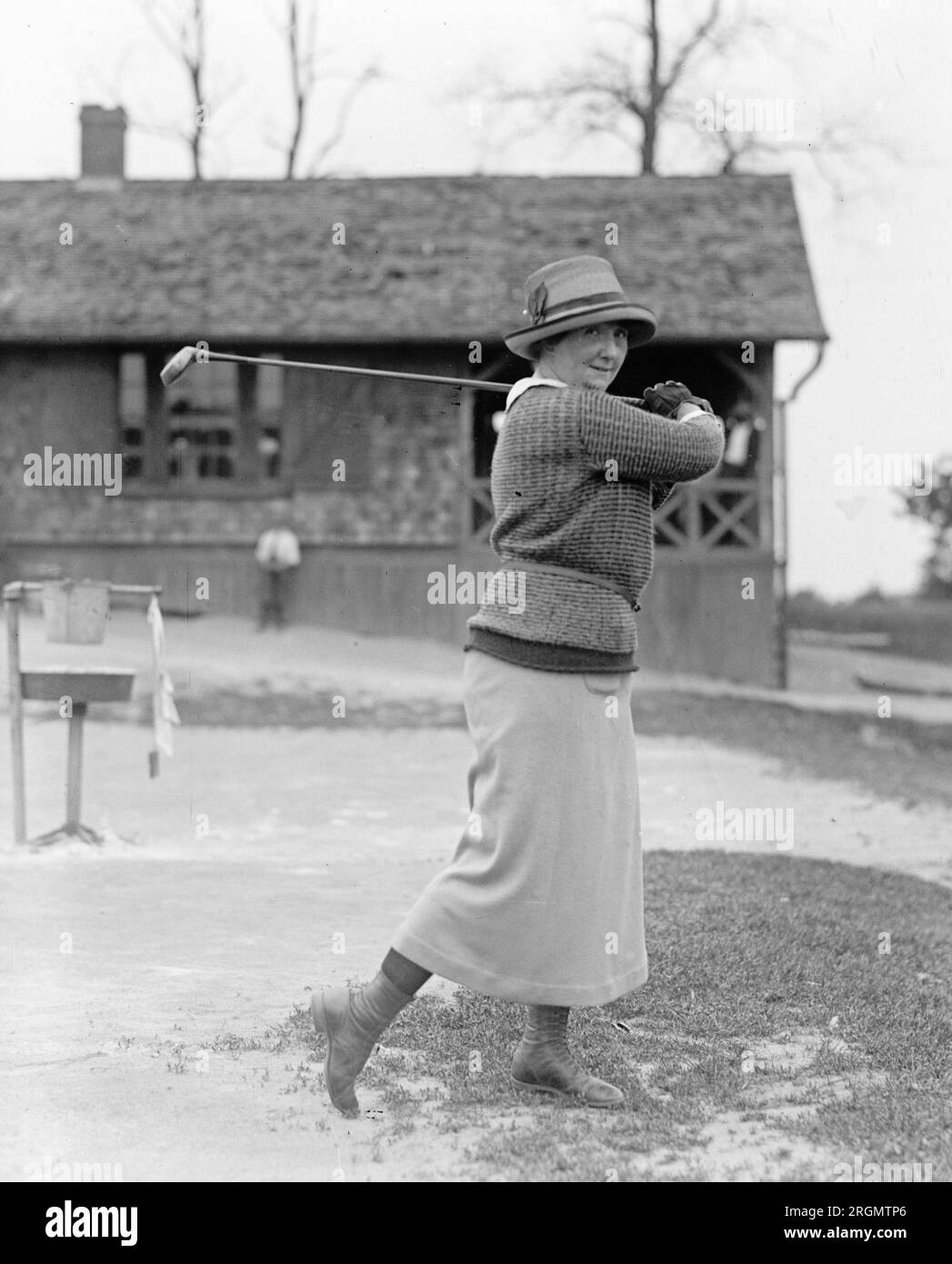 Unidentified woman golfer swinging a golf club ca. 1922 Stock Photo