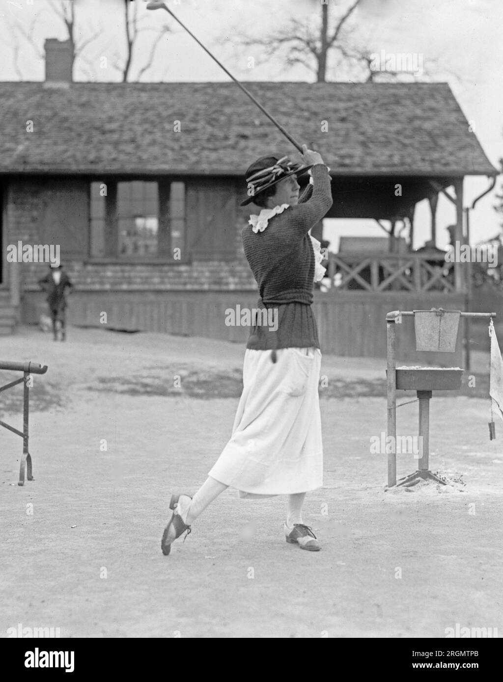 Unidentified woman golfer swinging a golf club ca. 1922 Stock Photo