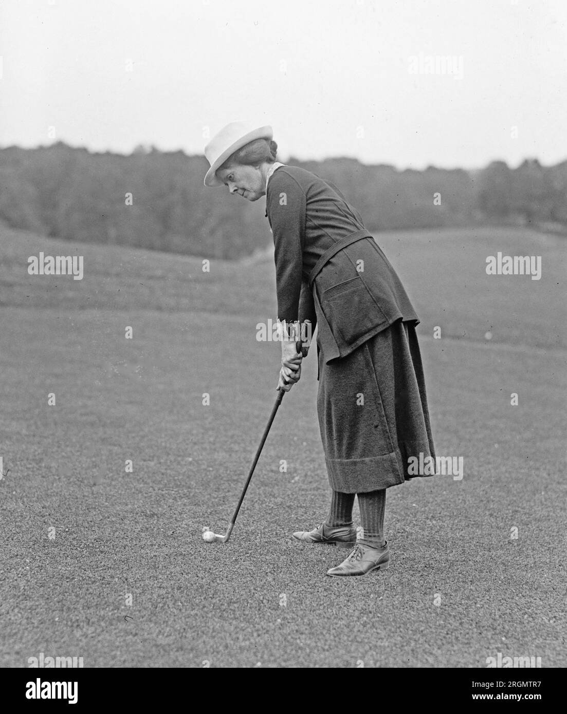 Unidentified woman golfer preparing to hit a golf ball ca. 1922 Stock Photo