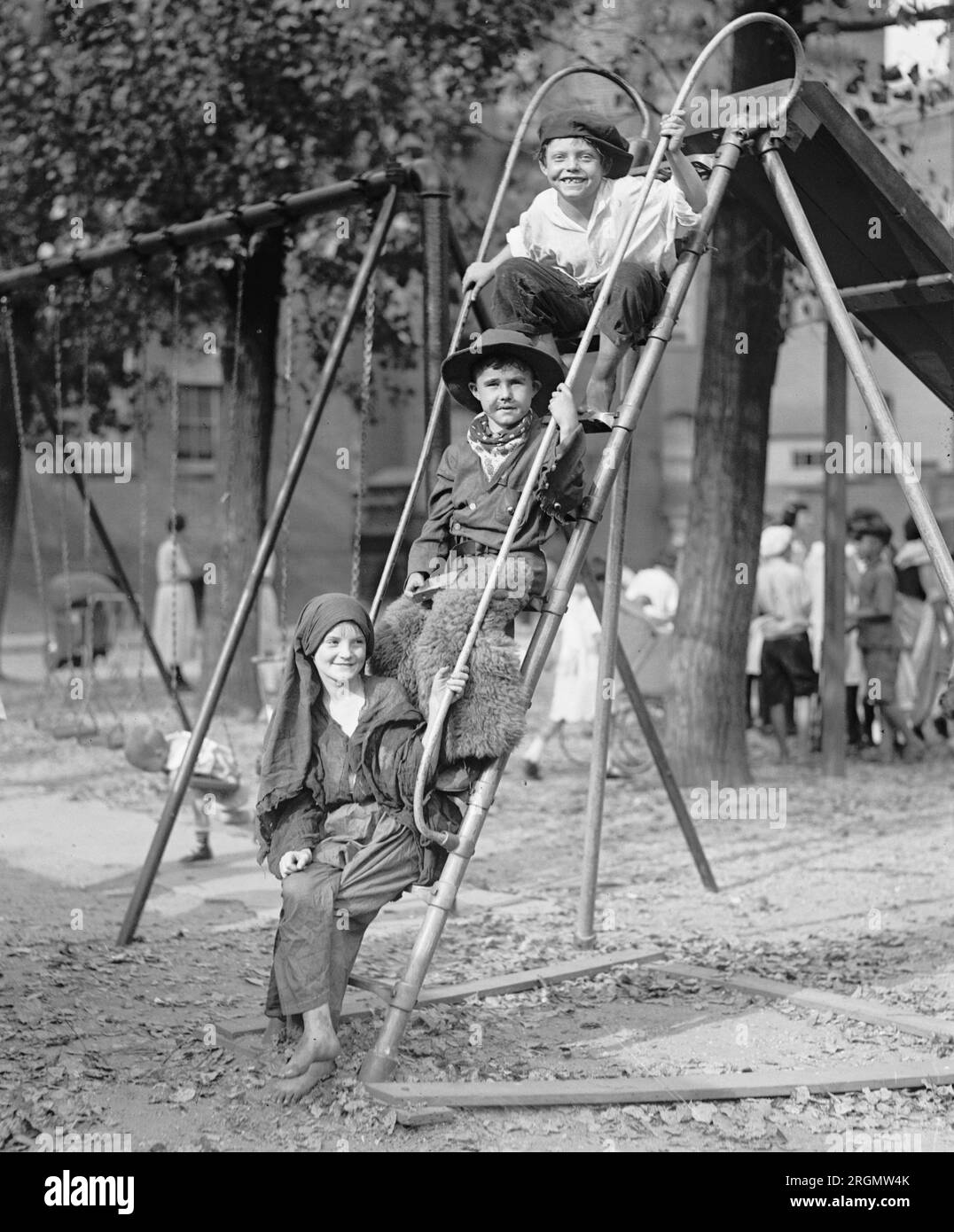 Children in costume on steps of a playground slide ca. 1922 Stock Photo