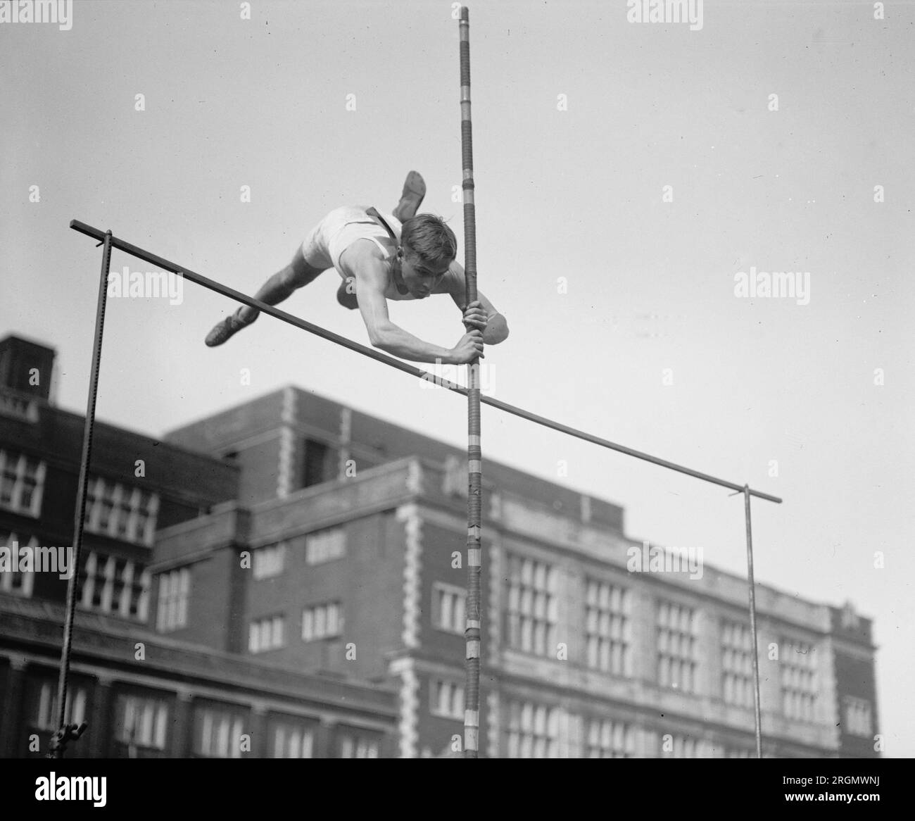 Vintage high jumper clearing a bar ca. 1923 Stock Photo
