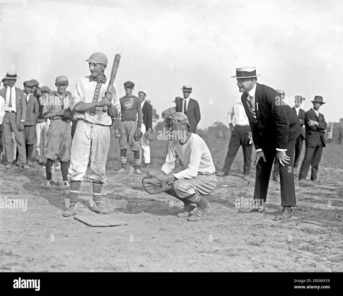 Boys playing baseball, man in a suit calling balls and strikes ca. 1923