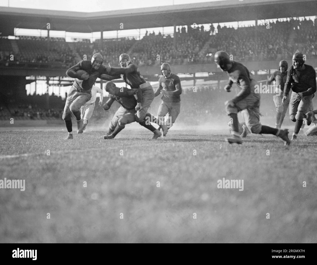 Running back giving a stiff arm to a tackler during the Georgetown vs. Marines game ca. 1923 Stock Photo