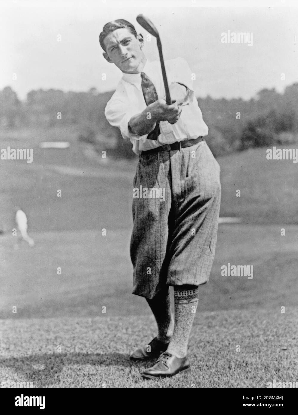 Vintage Golf: Tommy Armour, full-length portrait, facing front, swinging golf club ca. 1927 Stock Photo