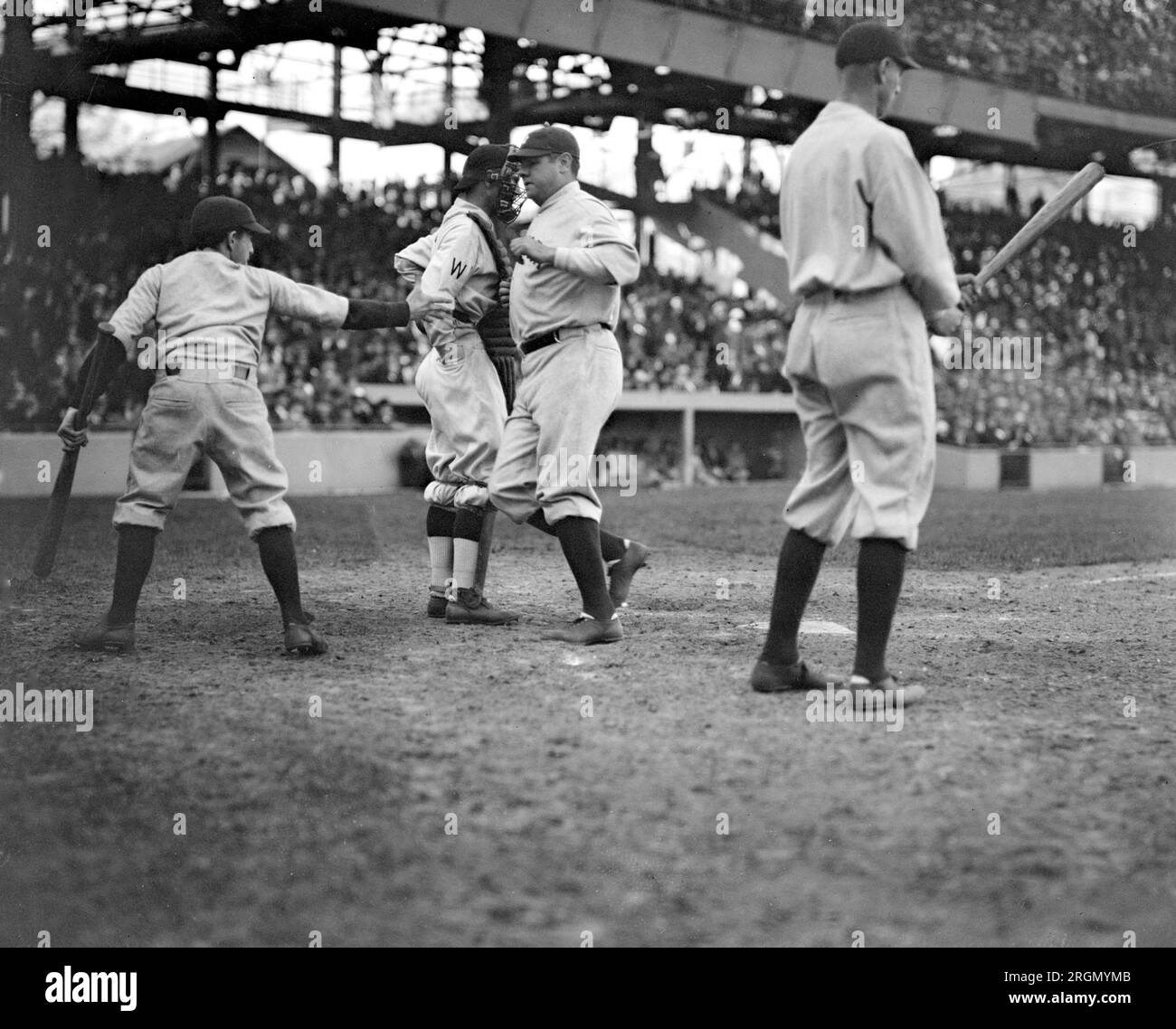 New York Yankees outfielder Babe Ruth crossing home plate after smashing his first home run on the 1924 season ca. April 1924 Stock Photo