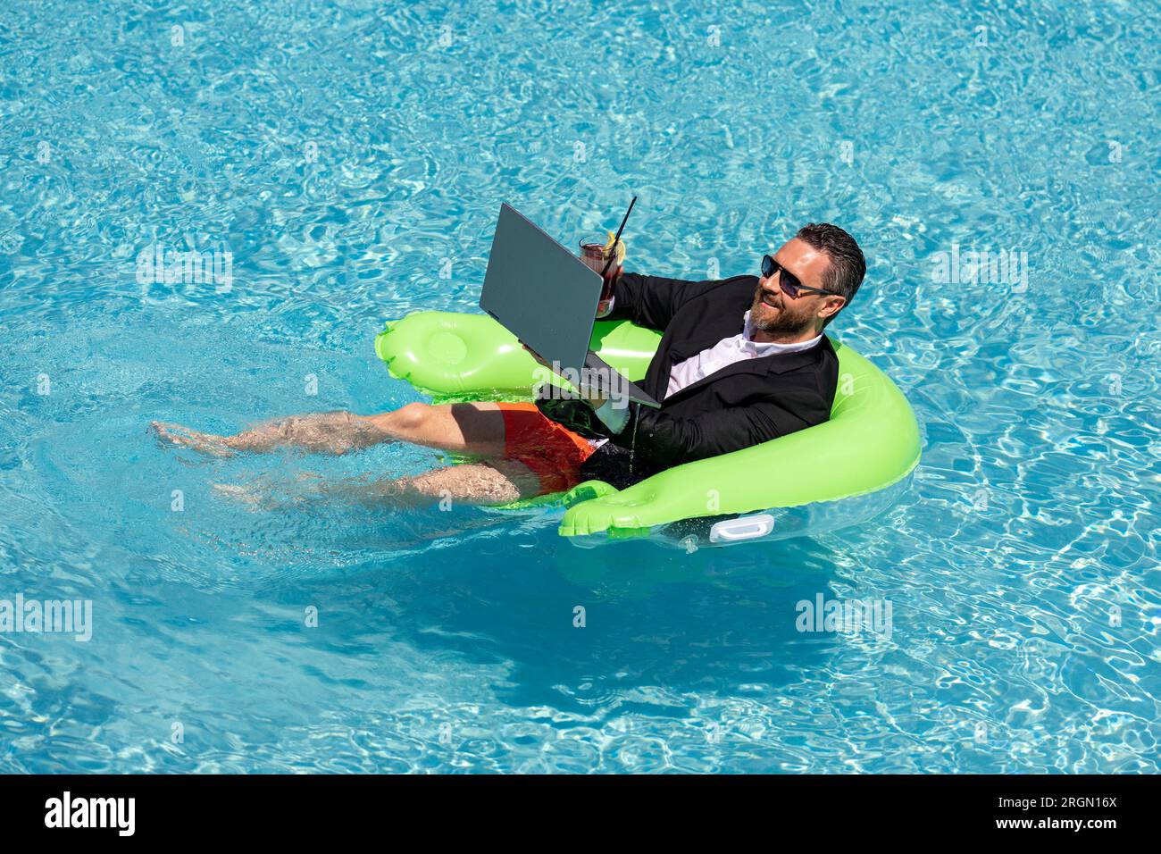 Business man in suit drink summer cocktail and using laptop in swimming pool.  Travel business tourism. Office employee using laptop in pool on summer  Stock Photo - Alamy