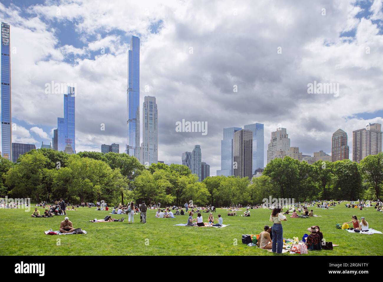 Central Park Great Lawn in Manhattan full of people laying on the grass