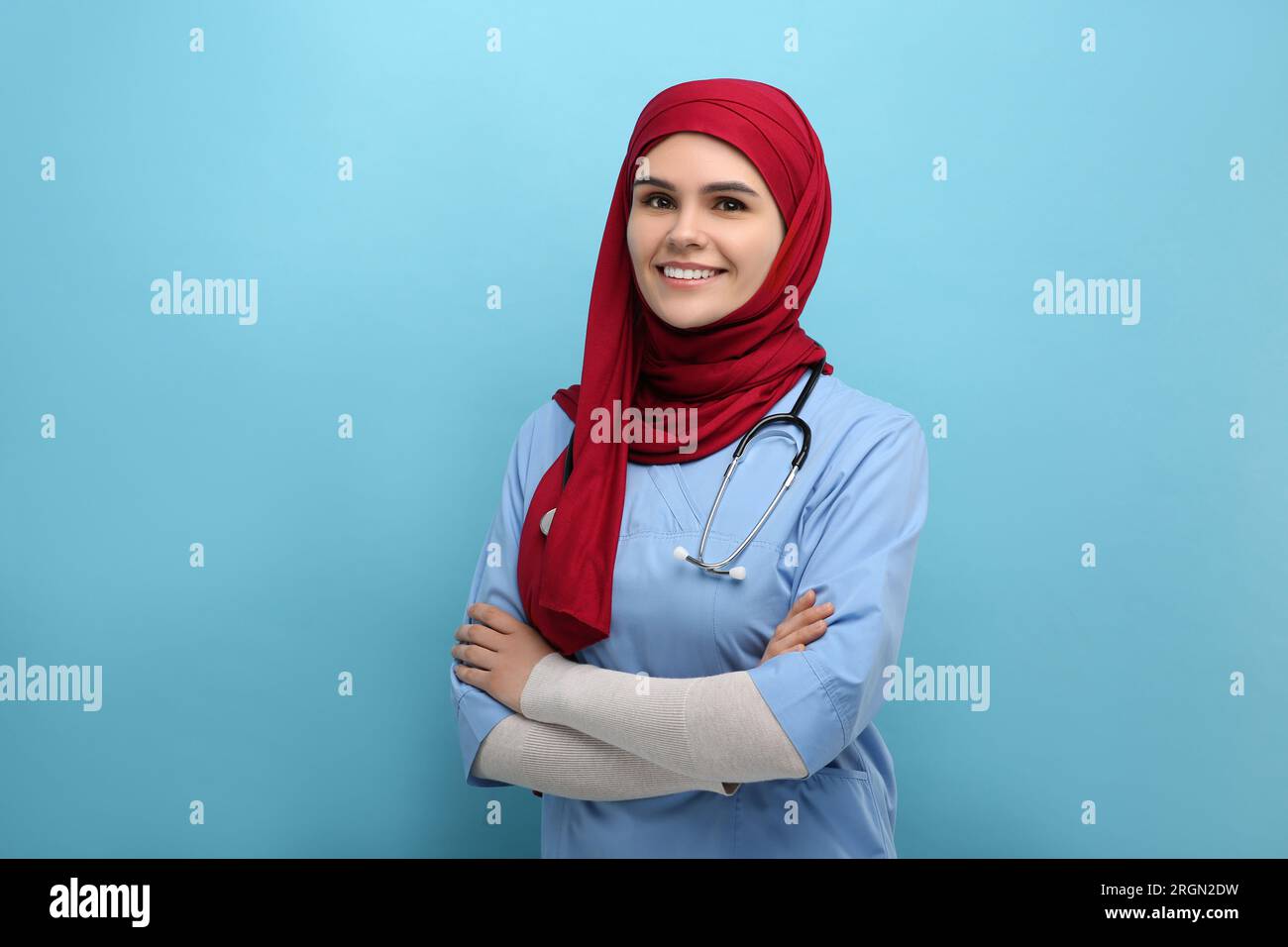 Muslim woman wearing hijab and medical uniform with stethoscope on
