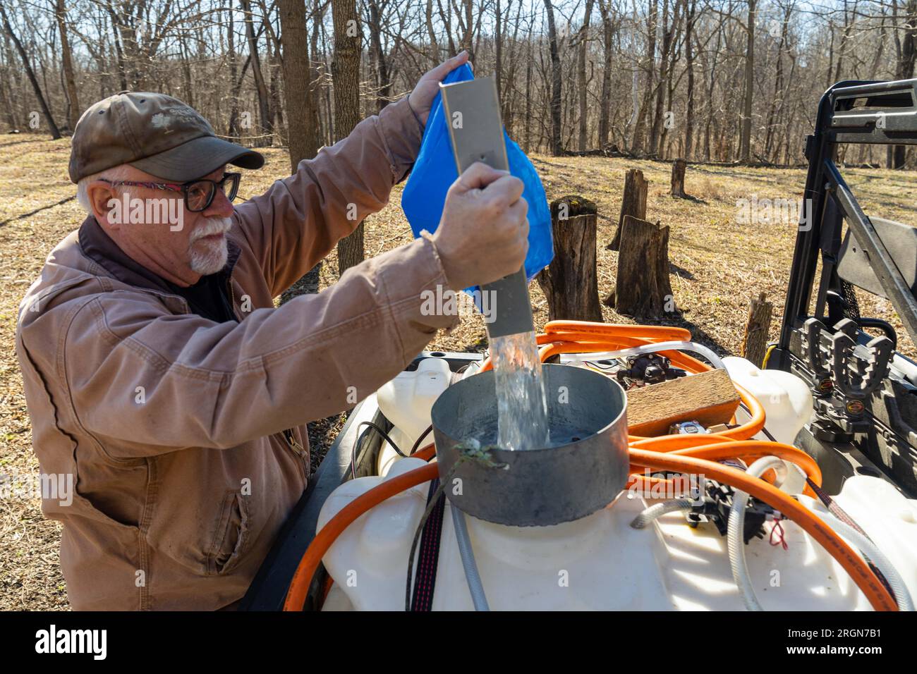 Reportage: USDA Visit to Springboro Tree Farms in Brookston, Indiana (Feb 2023) - Jim Hines collects maple sap at Springboro Tree Farms in Brookston, Indiana Feb. 13, 2023. Stock Photo