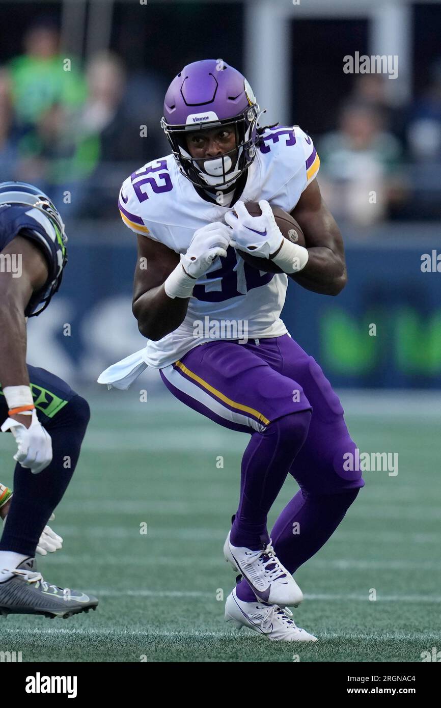 Minnesota Vikings running back Ty Chandler (32) runs against the