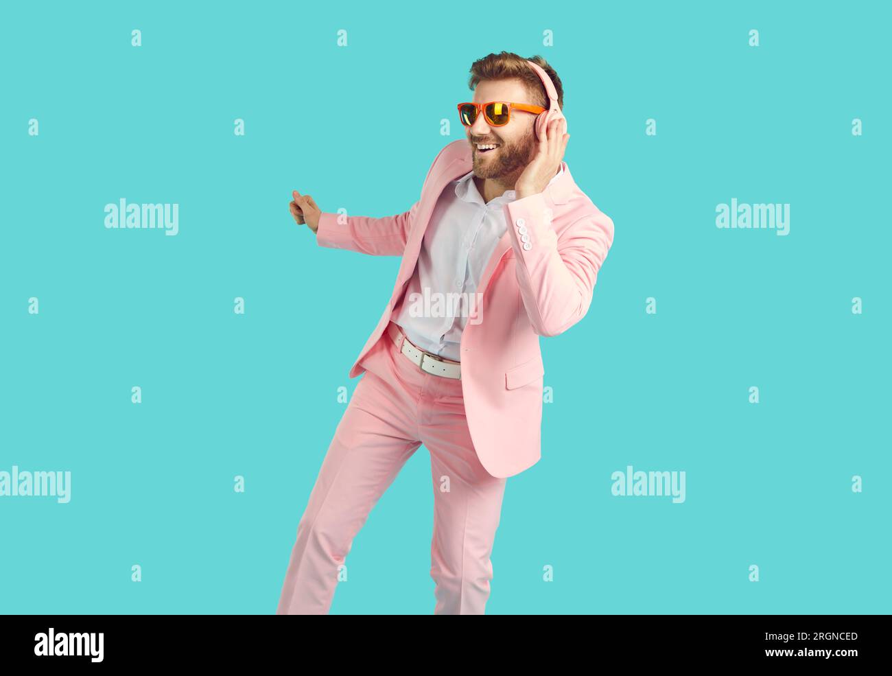 Cheerful happy young man in headphones dancing with happy smile Stock Photo