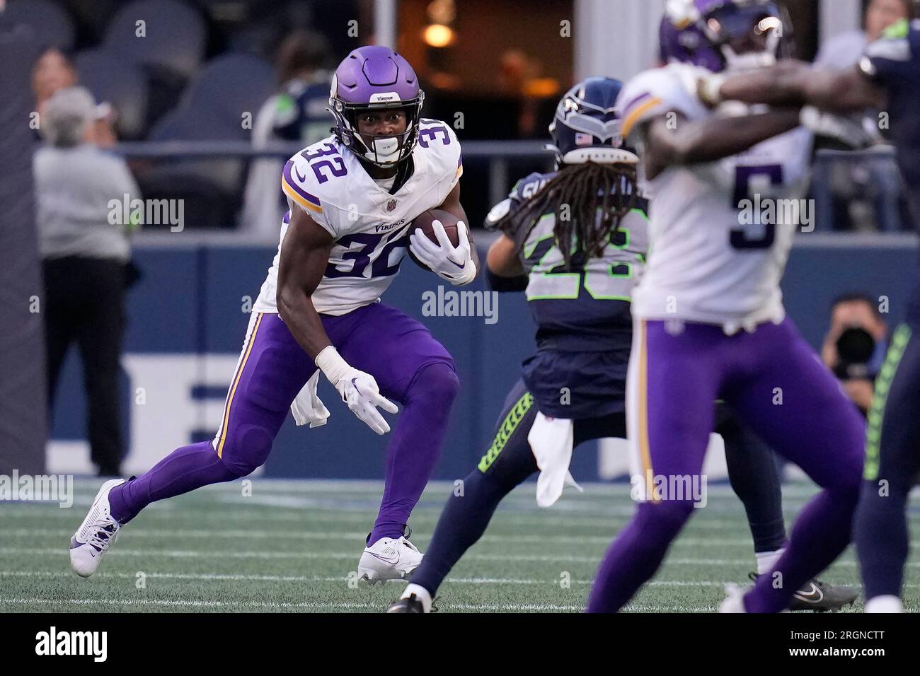 Minnesota Vikings running back Ty Chandler (32) runs against the