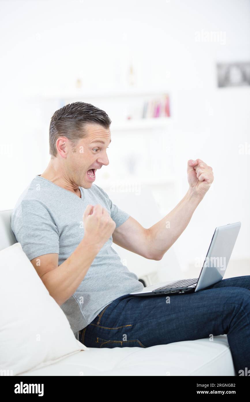 Excited man in front laptop hi-res stock photography and images - Alamy