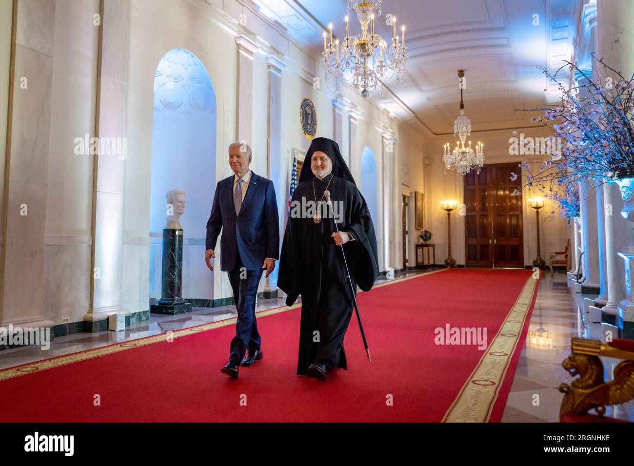 Reportage: President Joe Biden and Archbishop Elpidophoros walk through the Cross Hall to a Greek Independence Day reception, Wednesday, March 29, 2023, in the East Room of the White House. Stock Photo