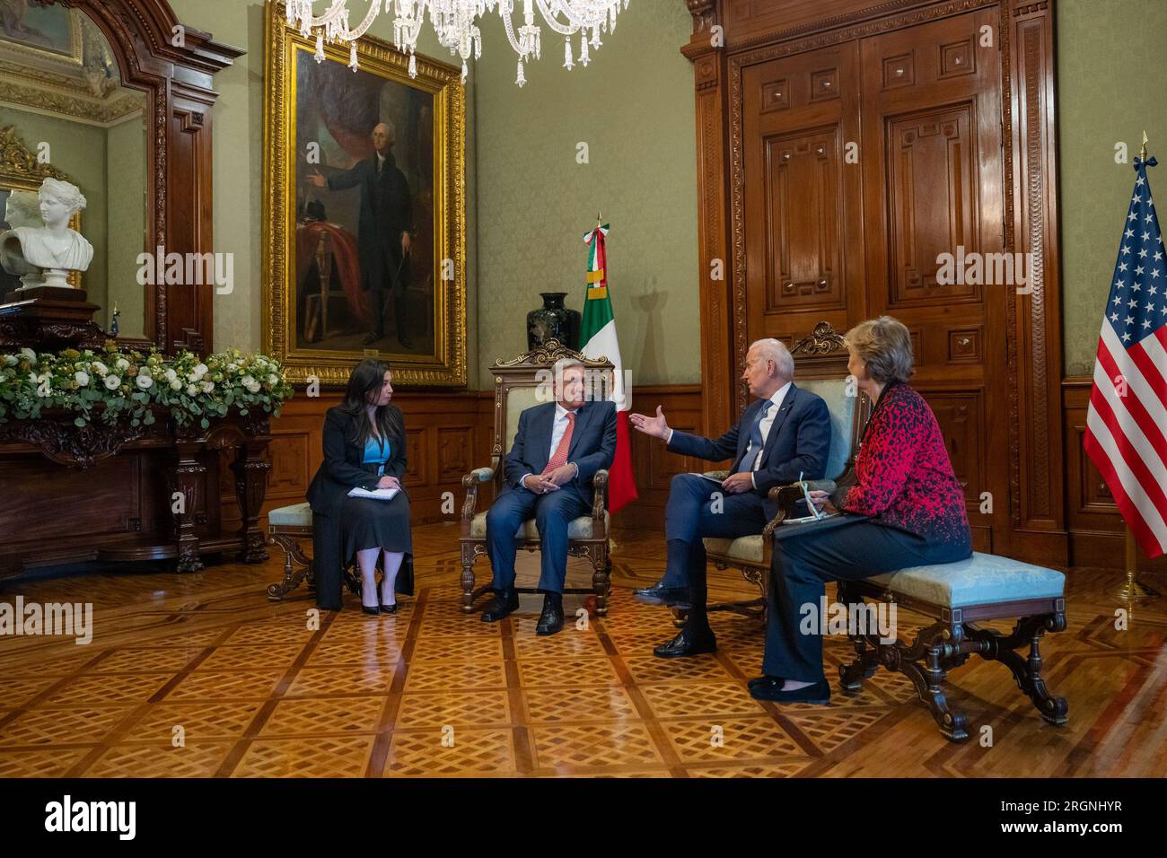 Reportage: Joe Biden, along with wife Jill Biden, visit Mexico City (January 2023) - President Joe Biden has a one-on-one private meeting with Mexican President Andres Manuel Lopez Obrador, Monday, January 9, 2023, at the National Palace in Mexico City. A replica of the iconic Gilbert Stuart portrait of George Washington hangs on the wall behind them. Stock Photo