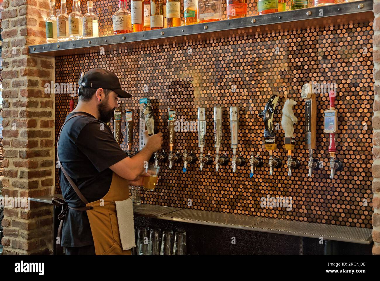 Bartender,  Alaskan Brewing House 'AKB Public House', preparing to serve selected beer, Juneau, Alaska. Stock Photo