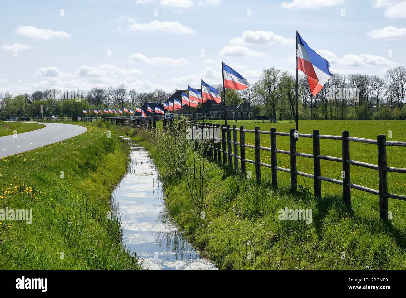 A row of dutch red white and blue upside down flags in The Netherlands. Protests against forced shrinking of livestock because of CO2 emissions. Stock Photo