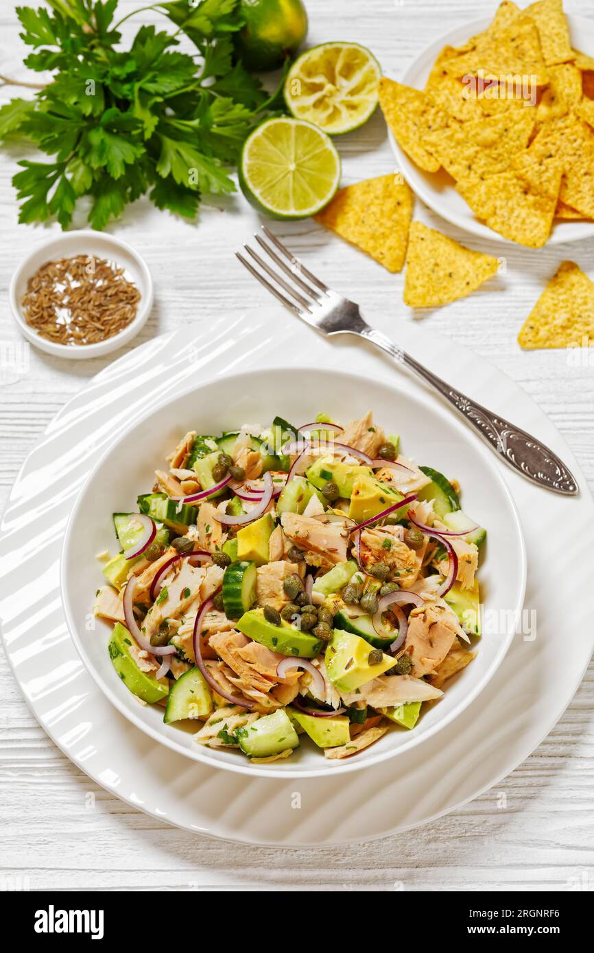 tuna salad with avocado, red onion, cucumber and capers with olive oil