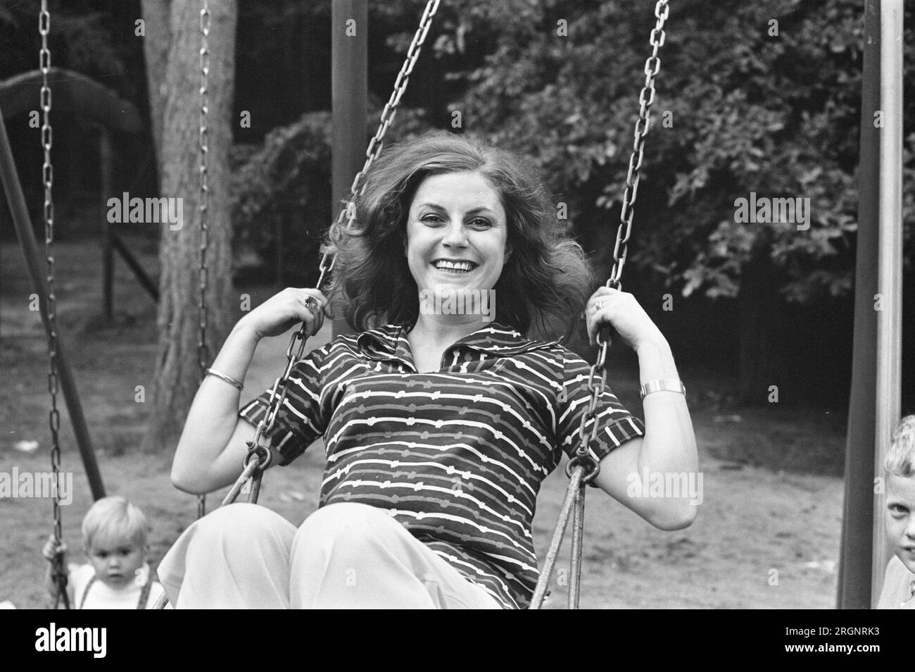 Dutch singer Conny Vink at the Amersfoort Zoo, having fun on a swing set ca. August 1972 Stock Photo