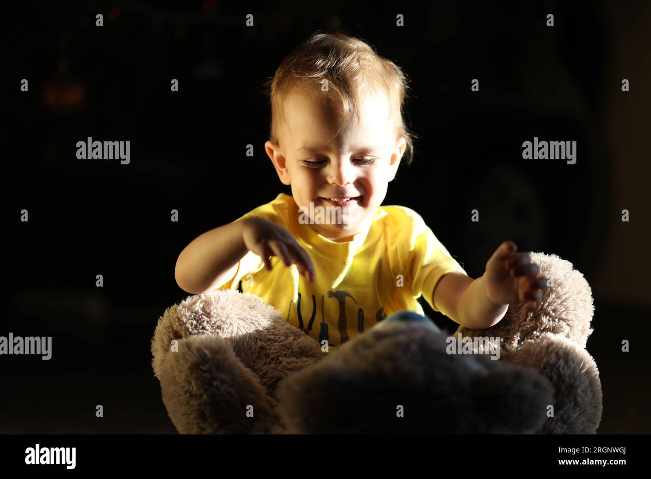Cute little boy playing with toy Teddy bear Stock Photo - Alamy