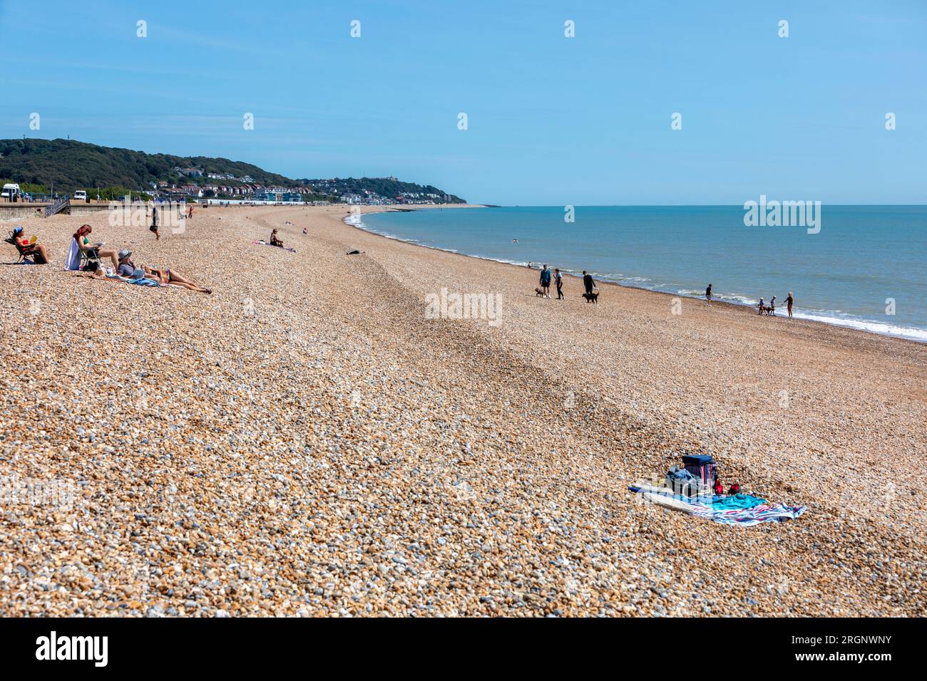 Holiday makers sunbathing on Hythe Beach on a sunny August day Stock Photo