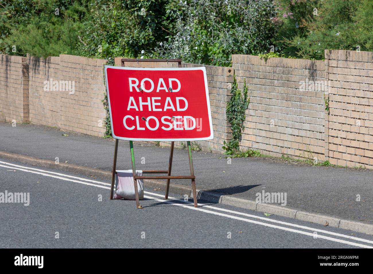 A red and white road ahead closed sign Stock Photo