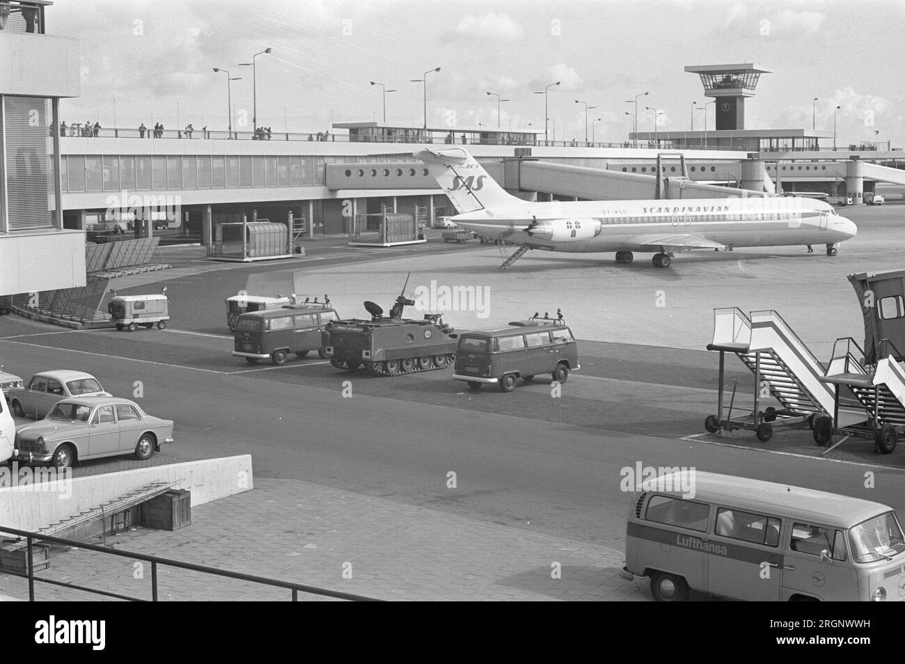 Armored vehicles near an SAS plane (Scandanavian Airlines) at Schiphol ca. September 1972 Stock Photo