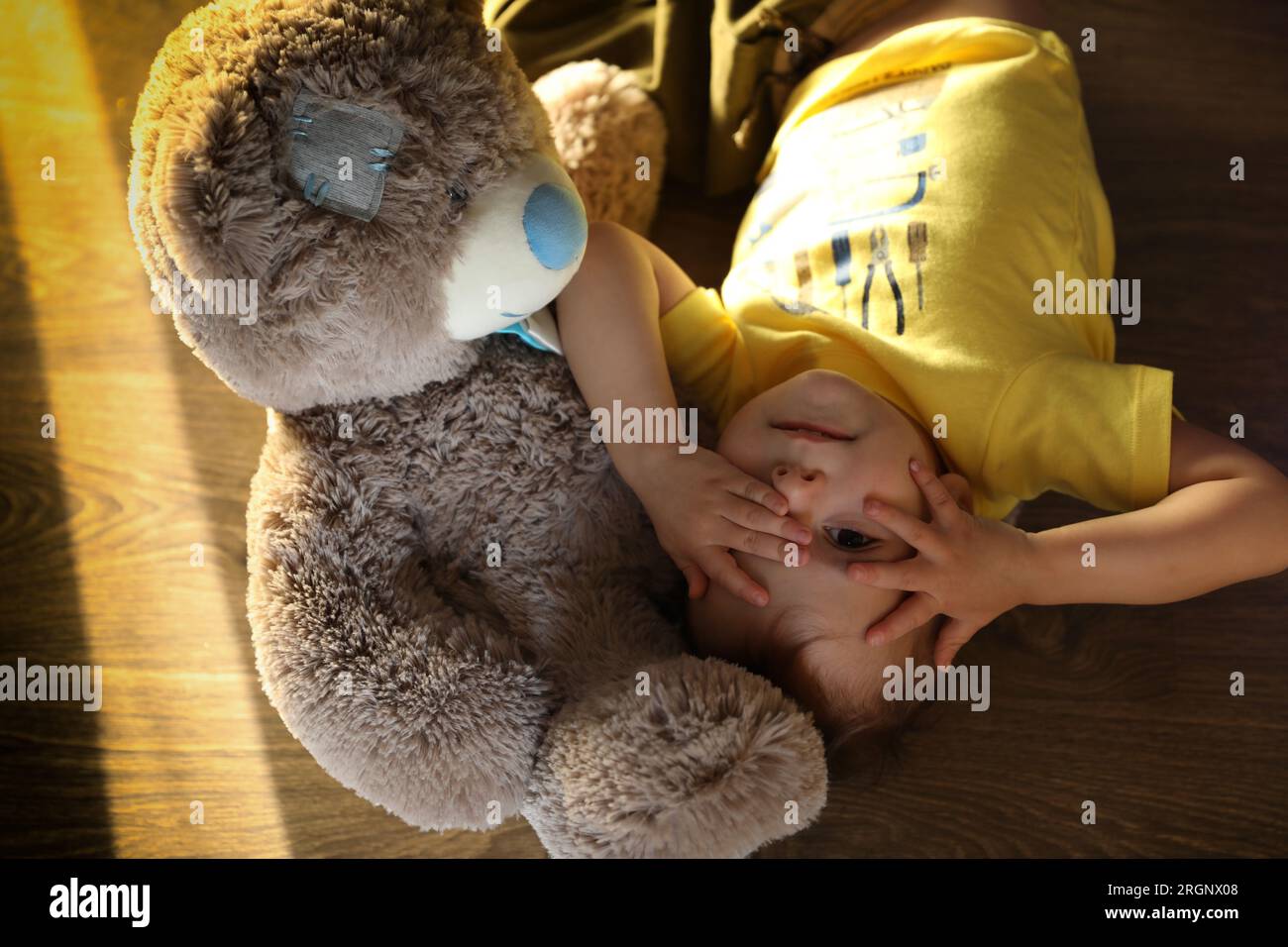 Cute little boy playing with toy Teddy bear Stock Photo - Alamy