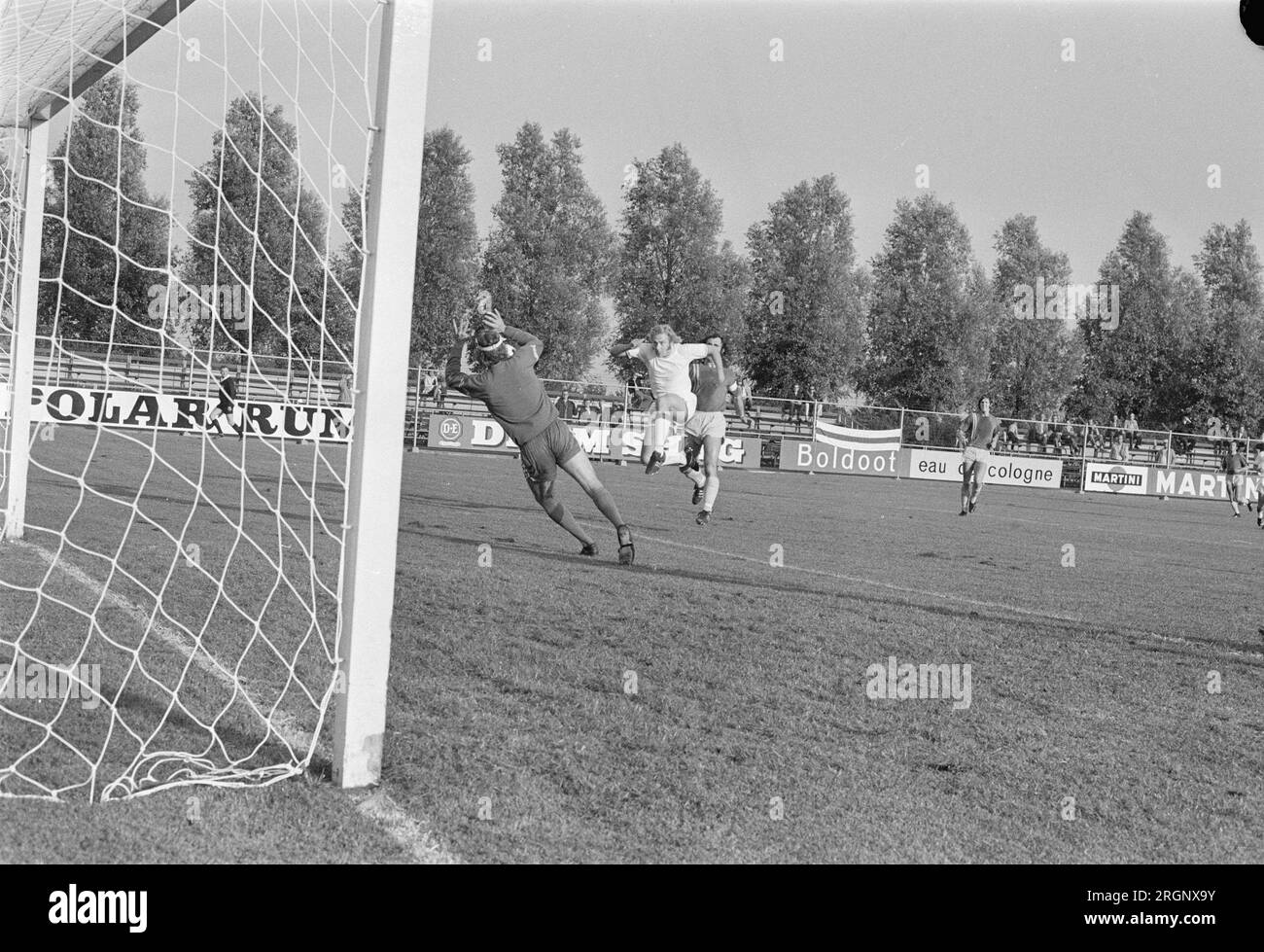Volewijckers against FSC 1-2, Fiene shoots into the hands of FSC keeper Nieuwing, number 8 Ger Blok trainer Volewijckers (head); ca. August 1972 Stock Photo