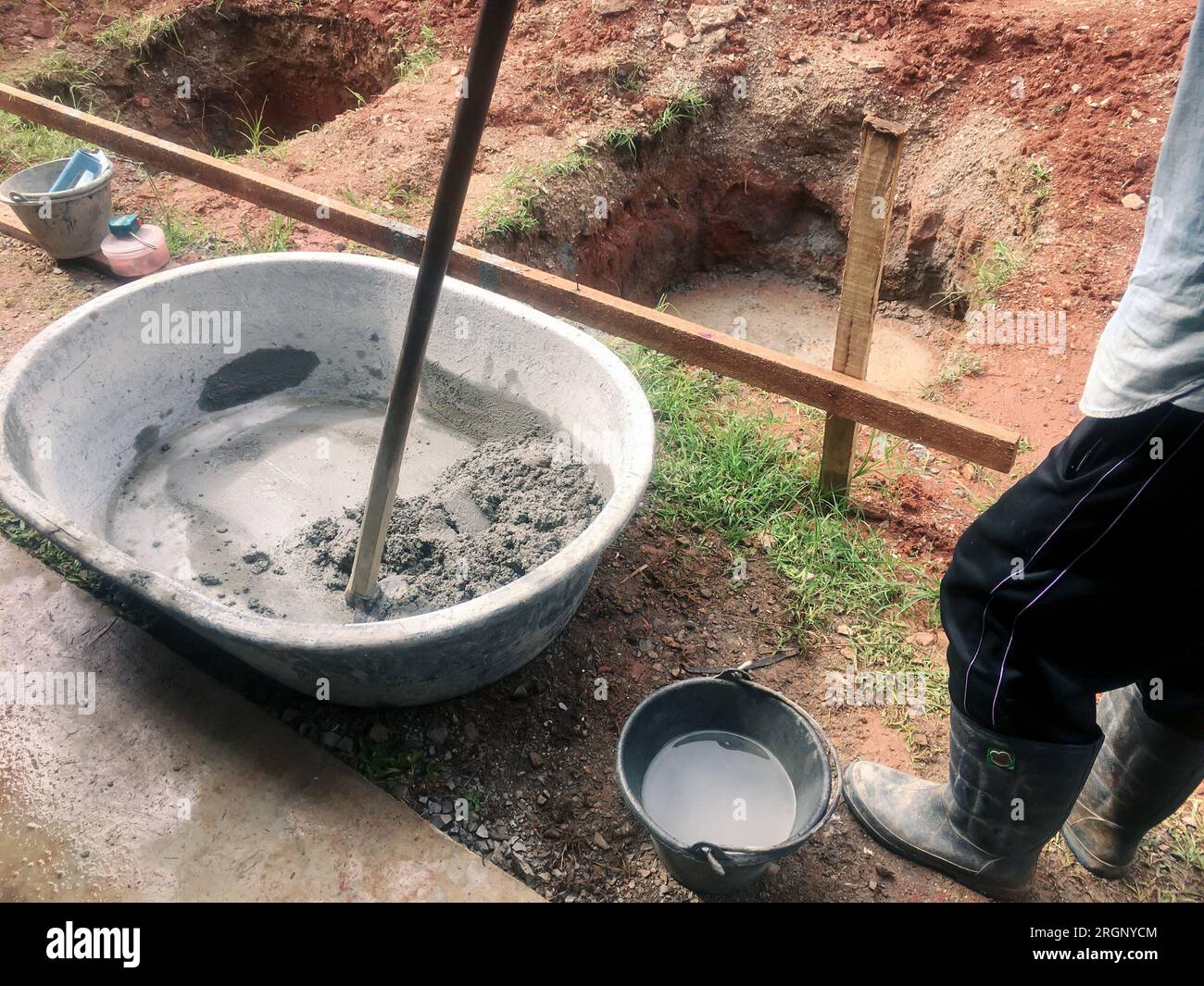 Mixing of stone, cement, sand together to make a strong concrete floor