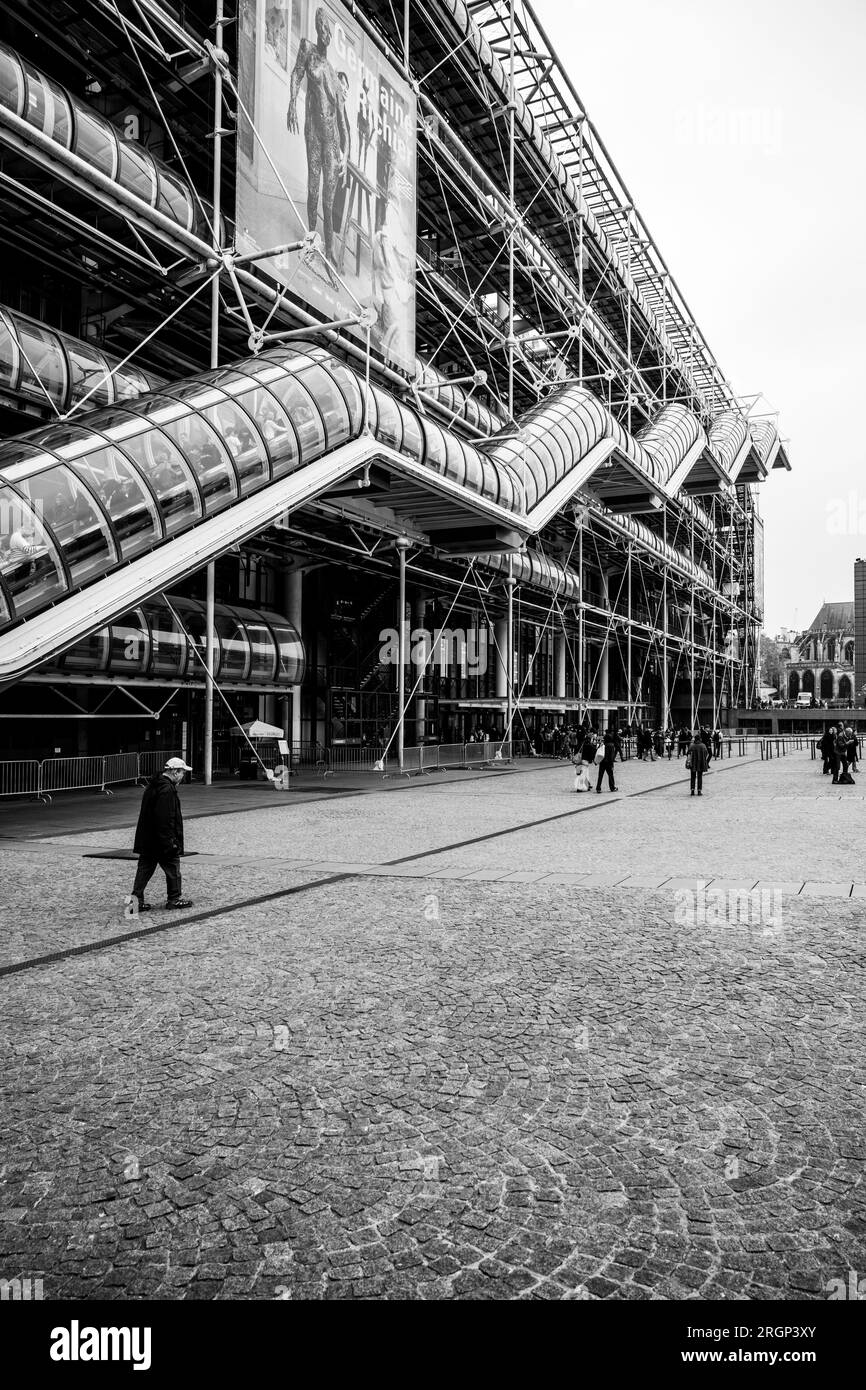 PARIS - APRIL 17, 2023: Centre of Georges Pompidou. View of modern futuristic glass and metal facade with staircase in tube. Paris, France. Full name: National Georges Pompidou Centre of Art and Culture. Black and white image. Stock Photo