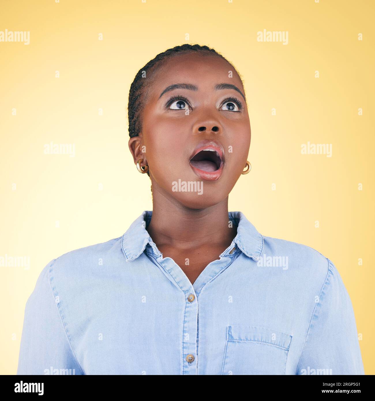 Thinking, wow and black woman with surprise, announcement and girl on a yellow studio background. Person, omg and model with expression, shocked and Stock Photo
