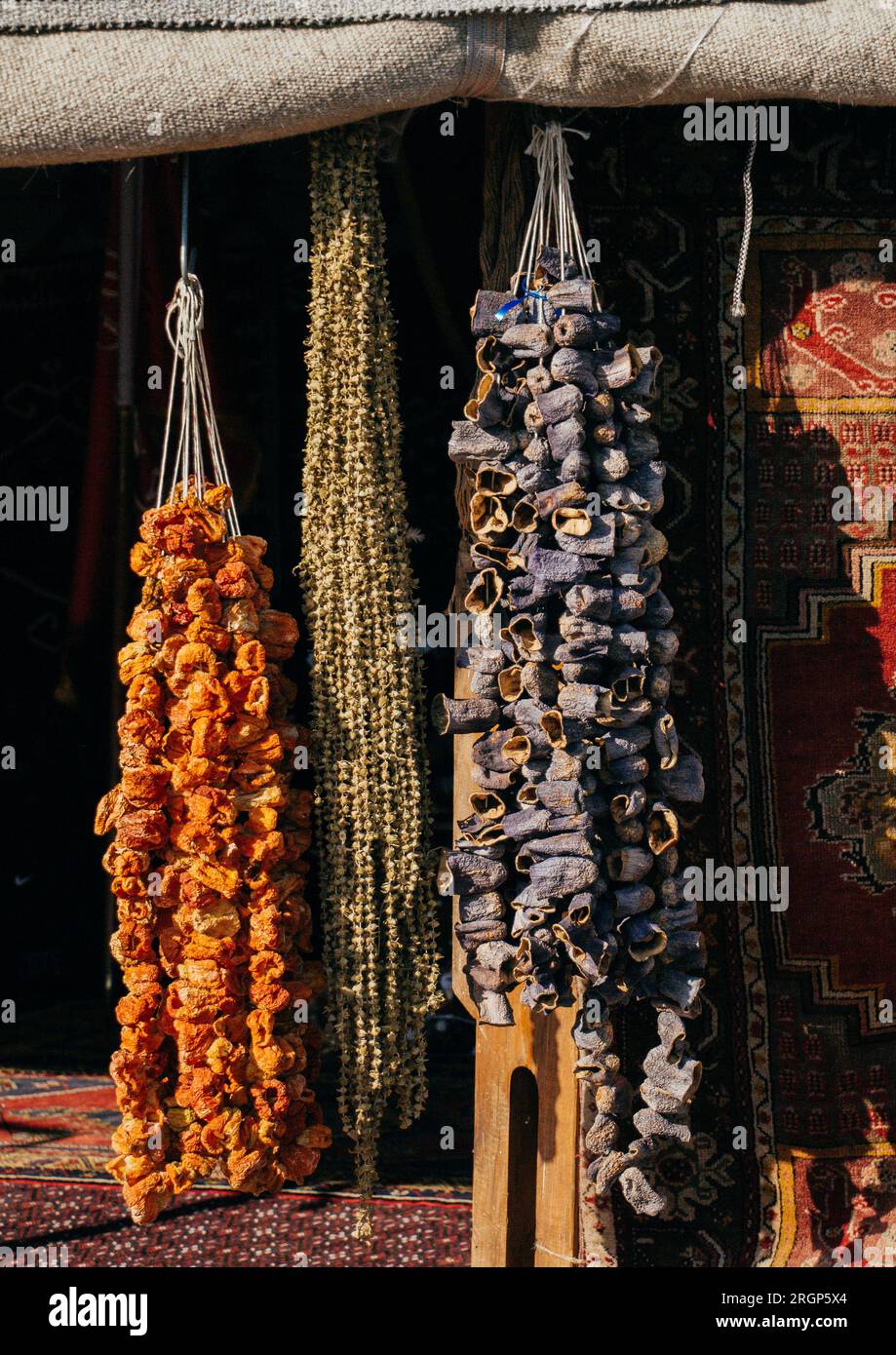 Dried red peppers and eggplants hanging on display Stock Photo - Alamy