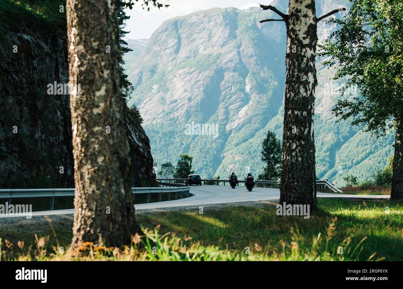 vehicles driving on a winding road around the Norwegian fjords Stock Photo