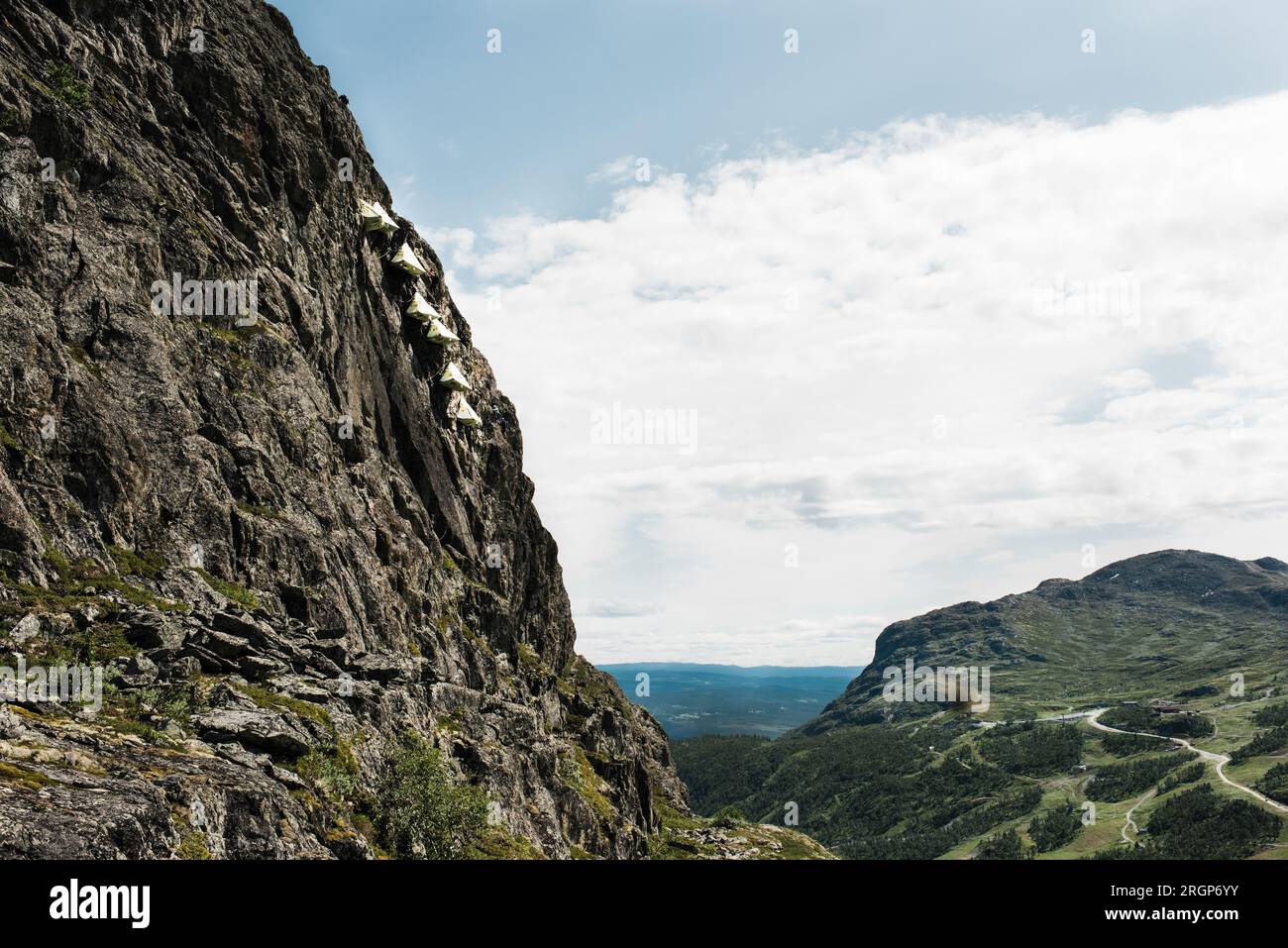 tents hanging off the side of a mountain face in Norway Stock Photo Alamy