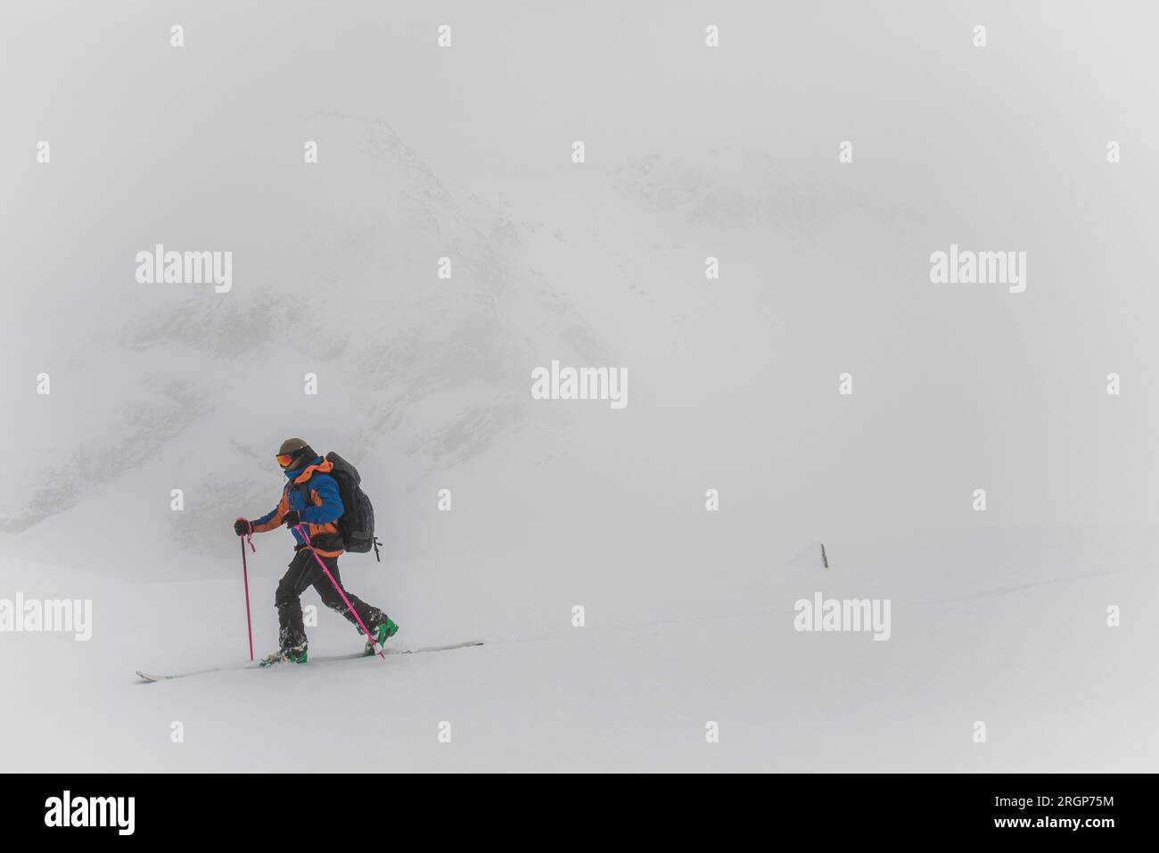 Man ski touring in white out conditions, poor visibility Stock Photo