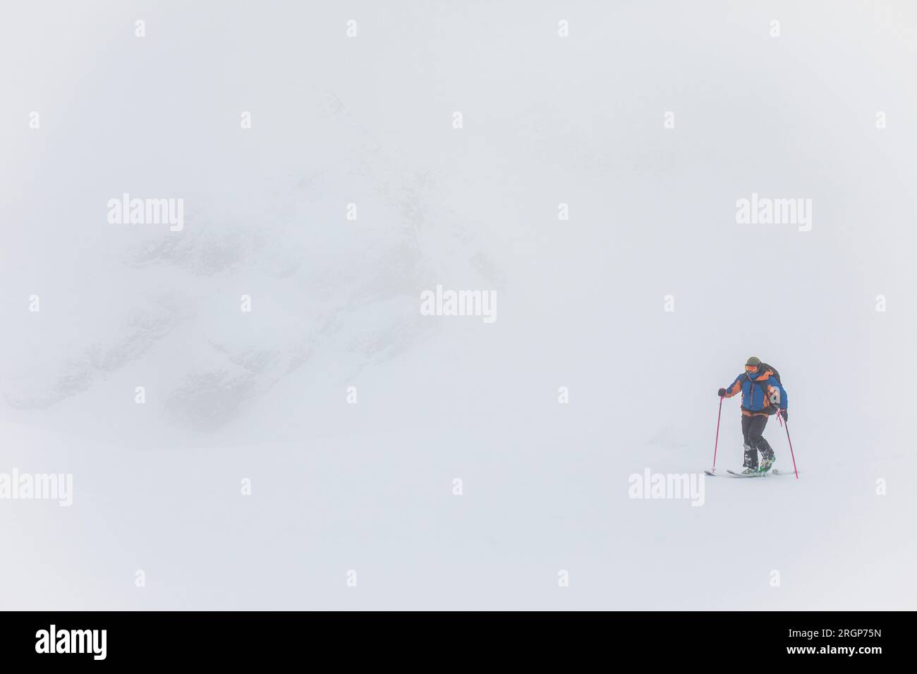 Man ski touring in white out conditions, poor visibility Stock Photo