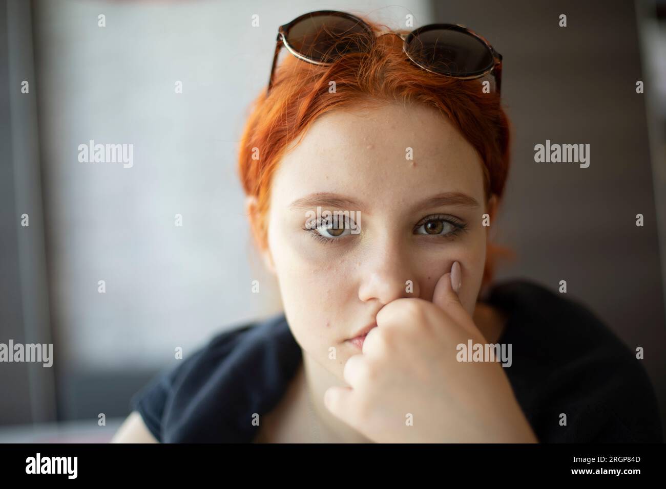 Young girl thinks. Woman's questioning gaze. Stock Photo