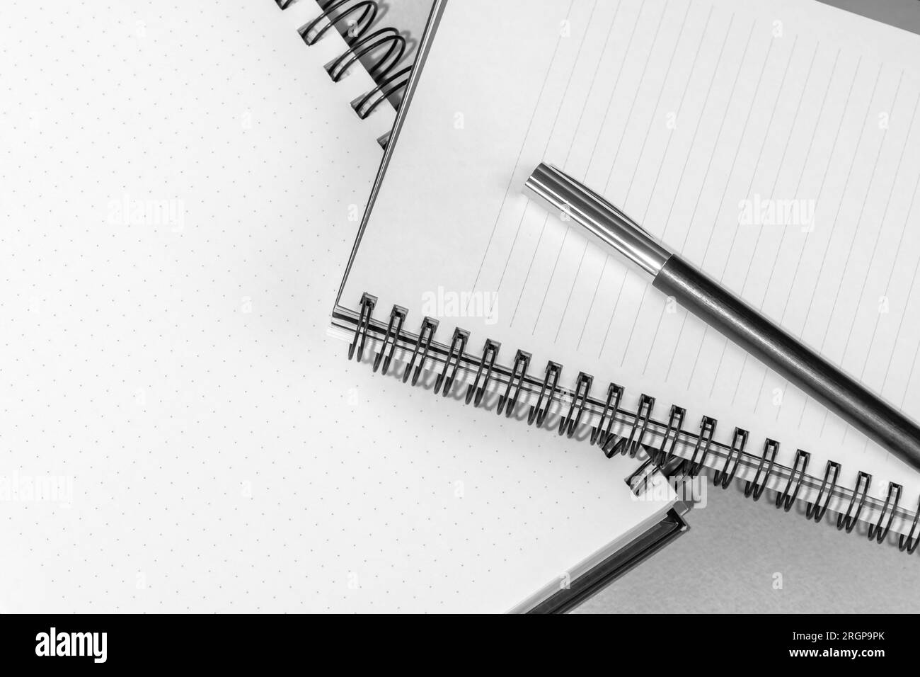 Notebook and pen. Shot of spiral notebook with pen on the office table. Stock Photo