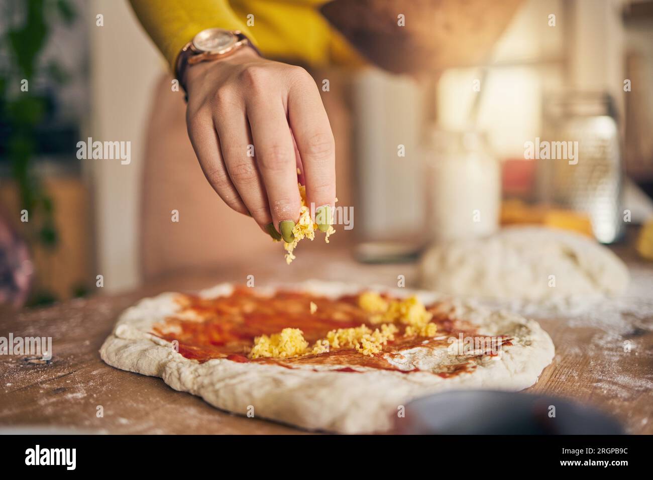 Hand, cheese and pizza for cooking, closeup and ready for food