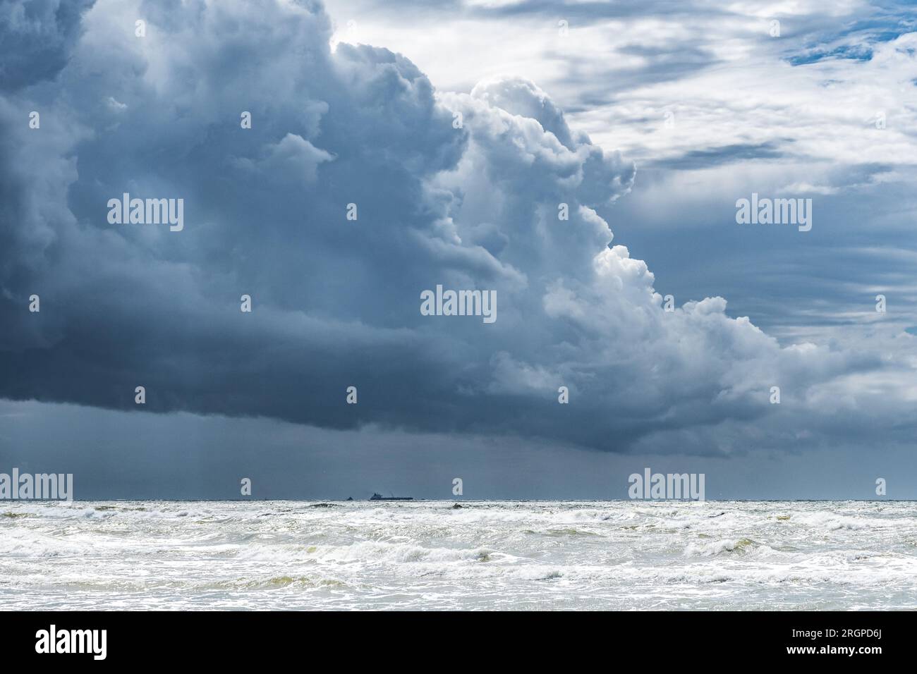 Beautiful rough sea with big waves, and dramatic cloudy sky with big dark clouds before the storm and rain Stock Photo
