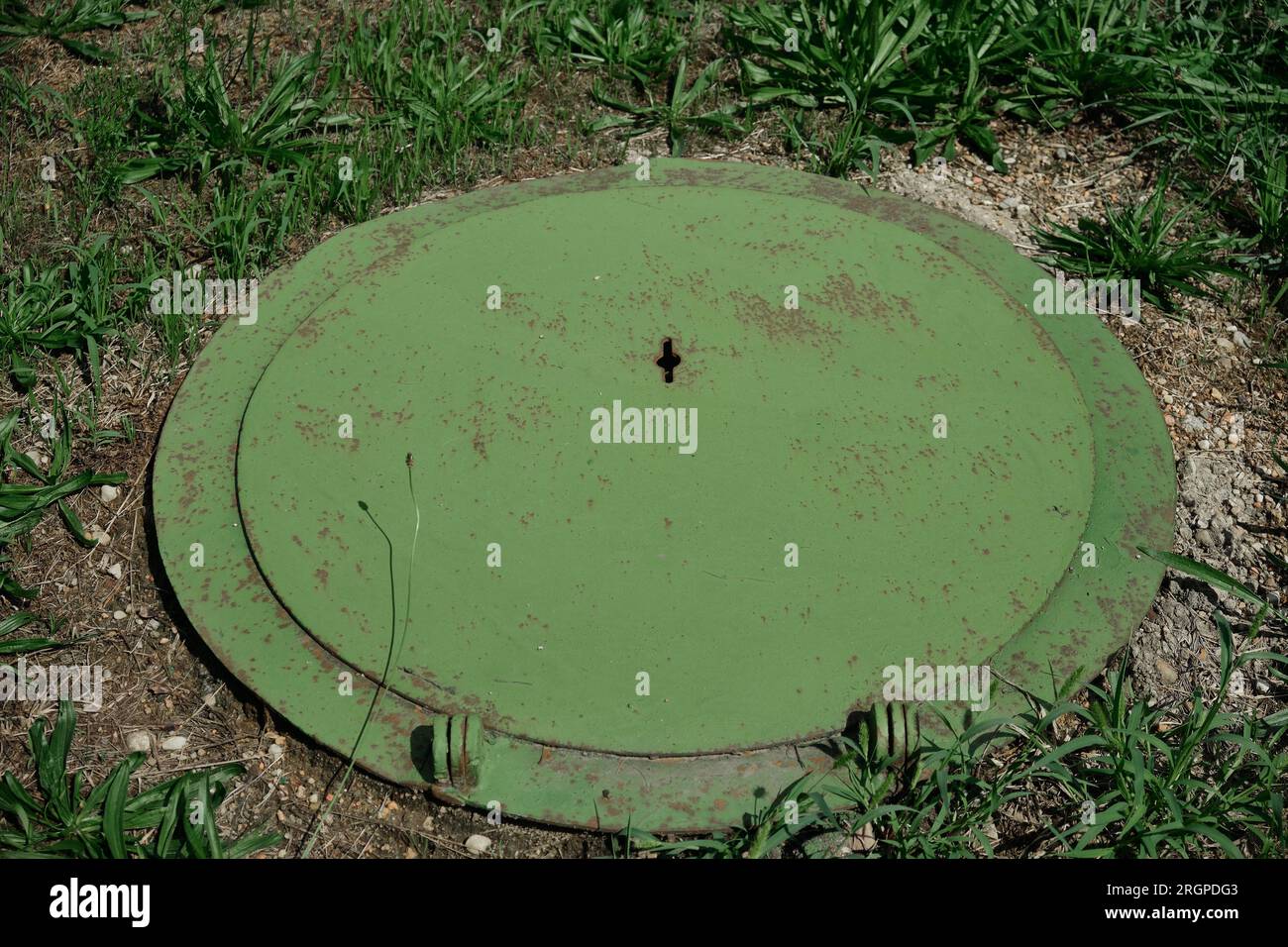 Green hinged cover sewer manhole. old design manhole covers, top view Stock Photo
