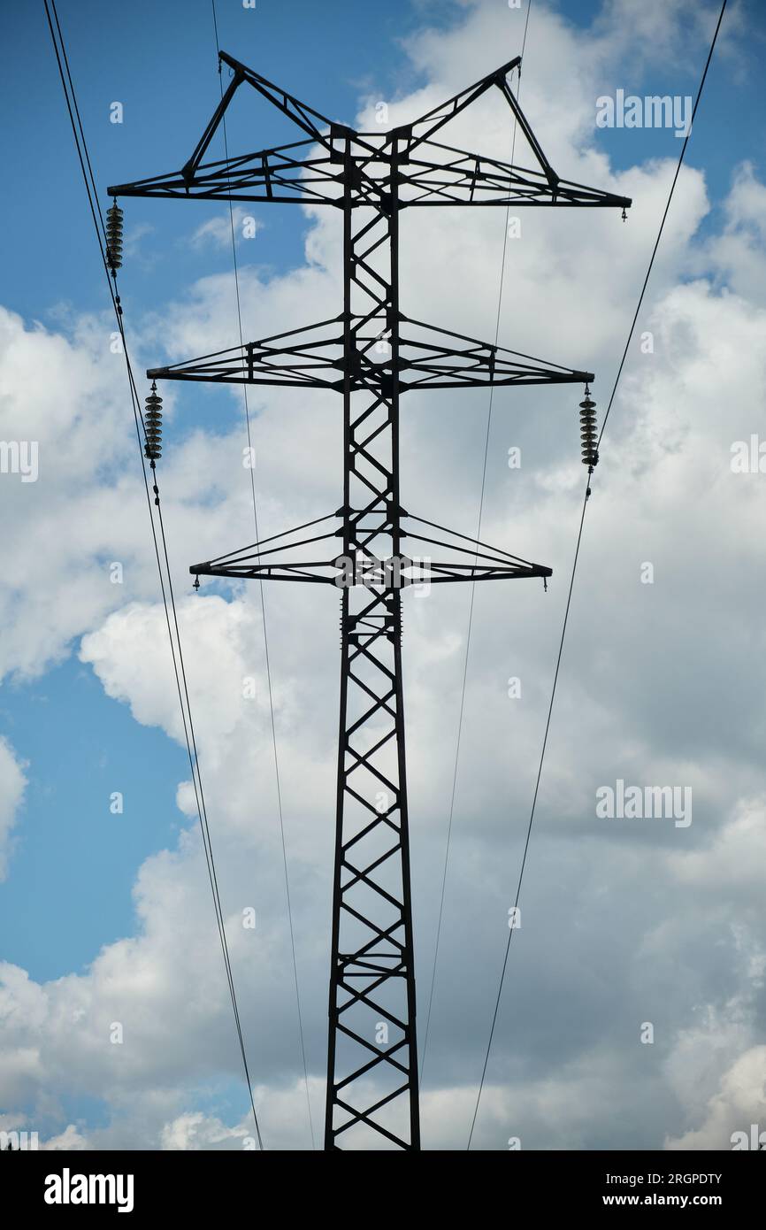High-voltage power line, electricity pylon, power line mast against the blue sky, wires and glass insulators. Energy concept Stock Photo