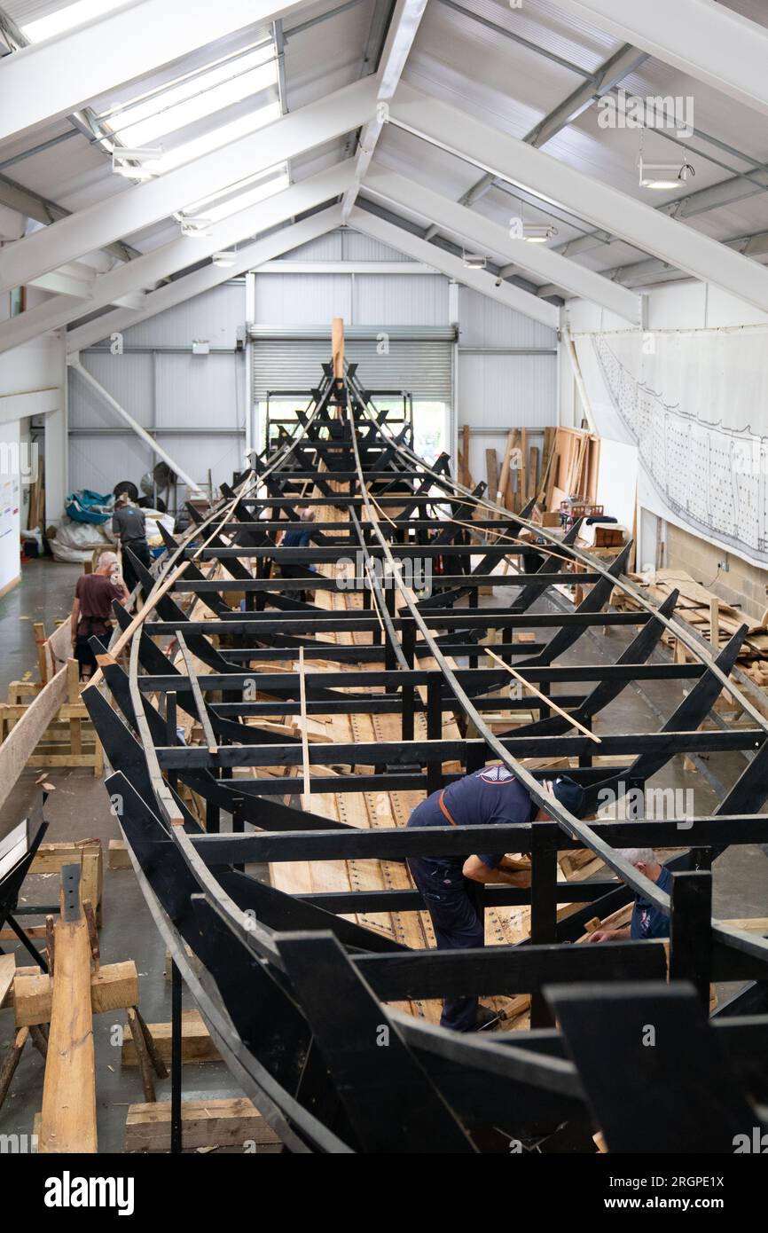Volunteers work on the replica of the Sutton Hoo longship, at the Longshed in Woodbridge
