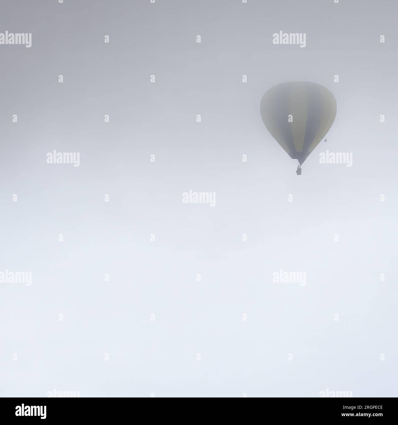 Hot air balloon vanishing into the clouds Stock Photo