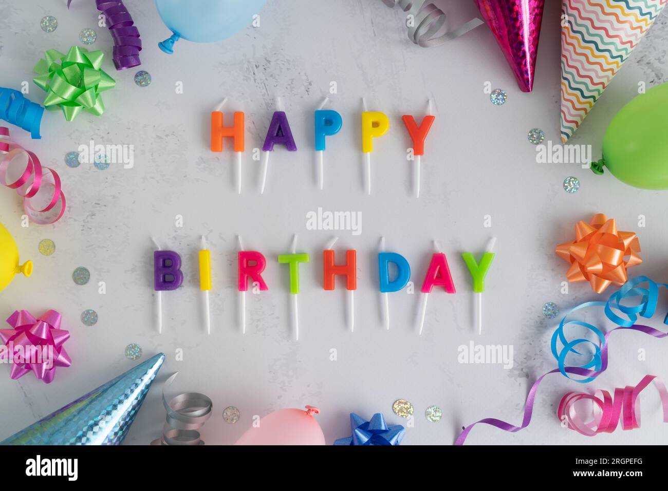 Happy Birthday cake candles letters, colorful balloons, cone hats, bows