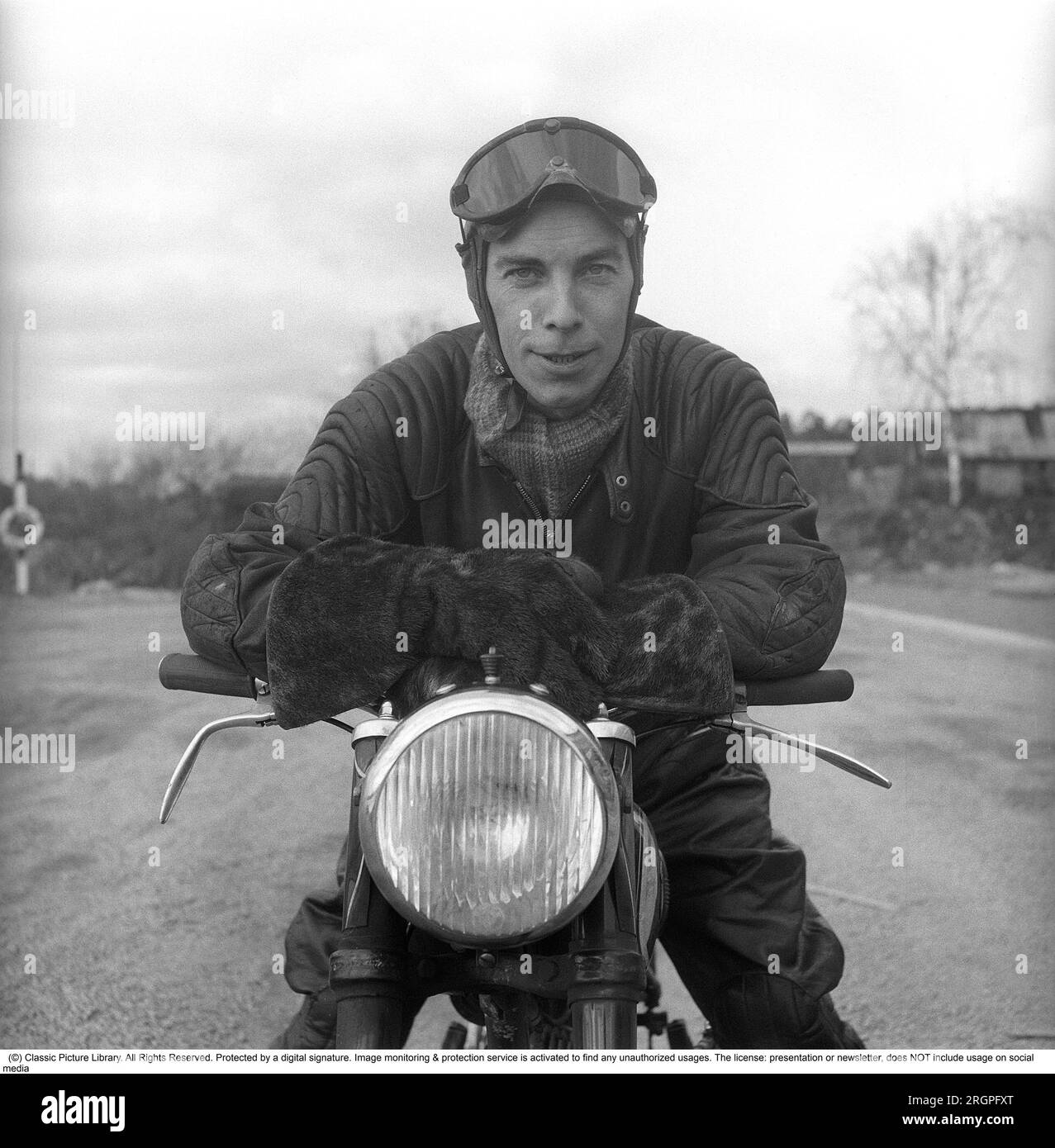 Motorcyclist in the 1950s. A young man dressed in the typical way the