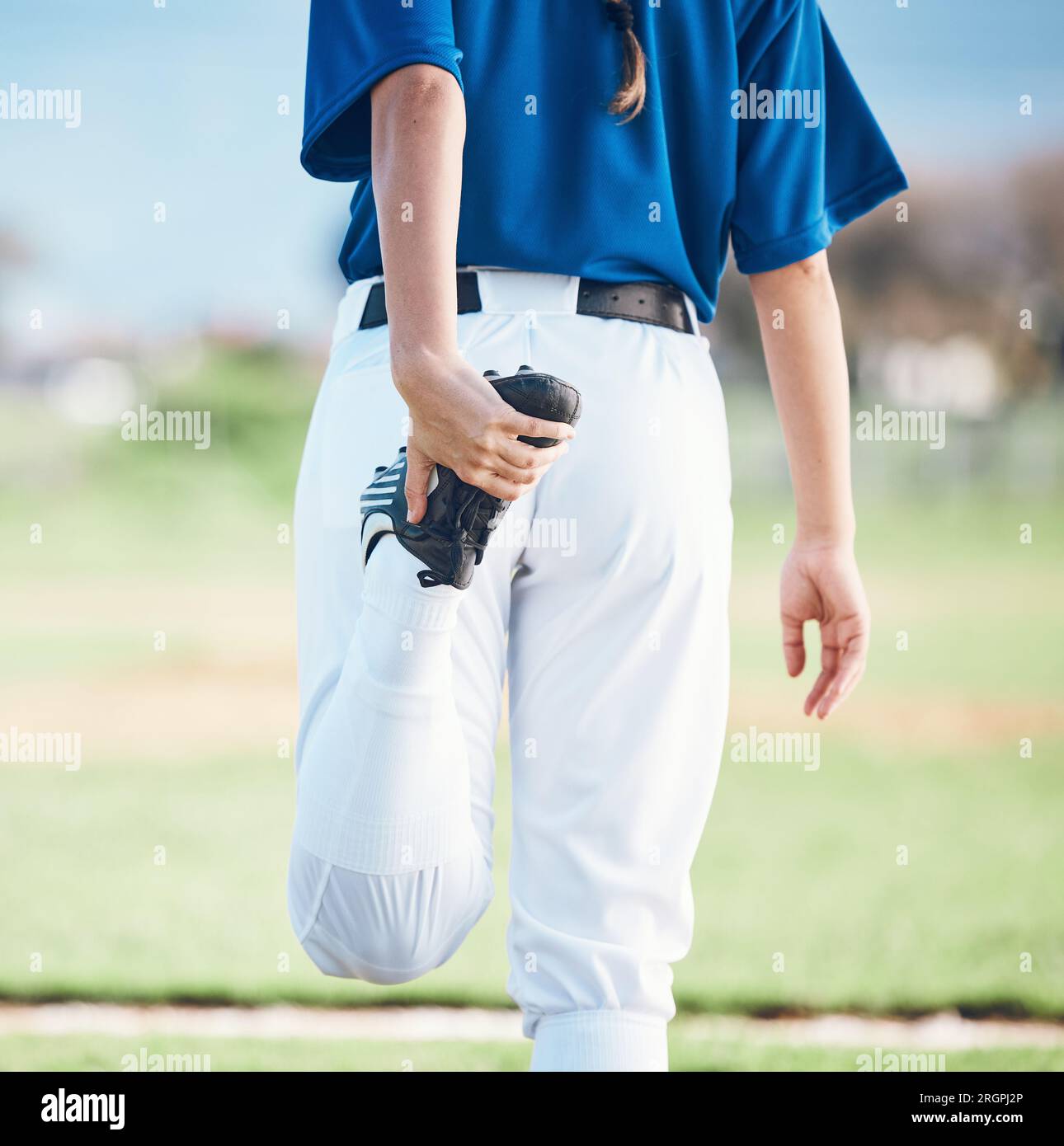 Back, softball and athlete stretching legs at field outdoor in healthy